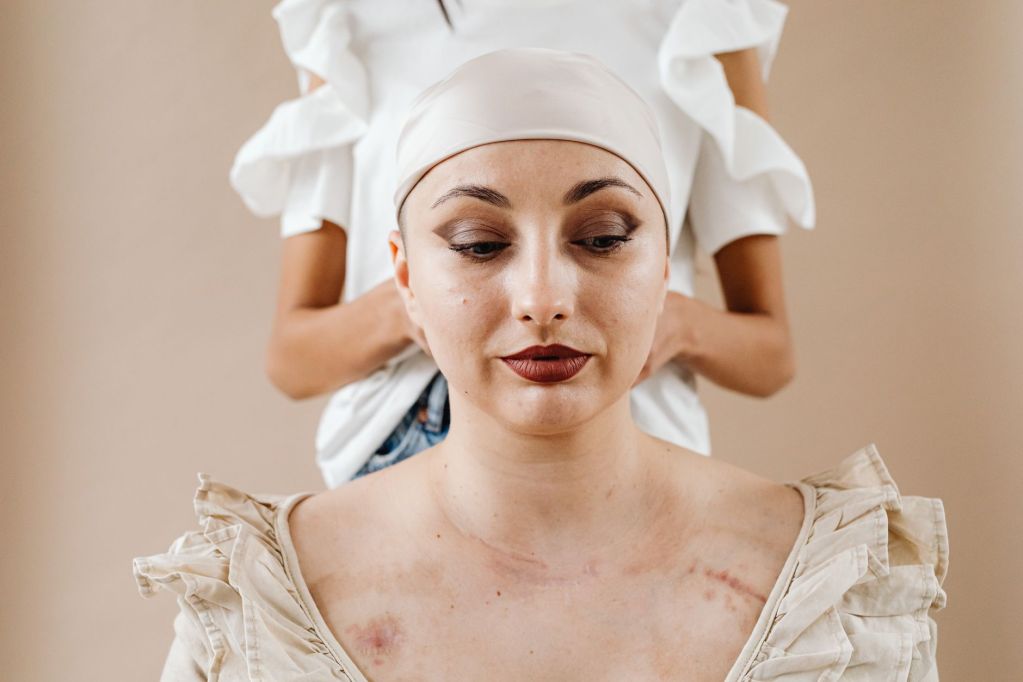 a woman in a headscarf with bruises on her body